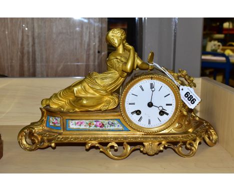 A FRENCH MIROY FRERES GILT METAL MANTEL CLOCK, a female beauty in classical dress holds a mirror, the enamel dial has Roman n