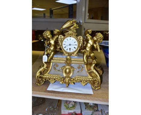 A LATE 19TH CENTURY GILT METAL AND ALABASTER MANTEL CLOCK, the white enamel dial flanked by two putti, Roman numerals, thirty