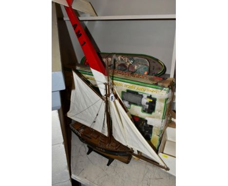 A PLASTIC BATTERY OPERATED REMOTE CONTROL TUG BOAT, no motor or remote control and has damage and missing items, a wooden scr