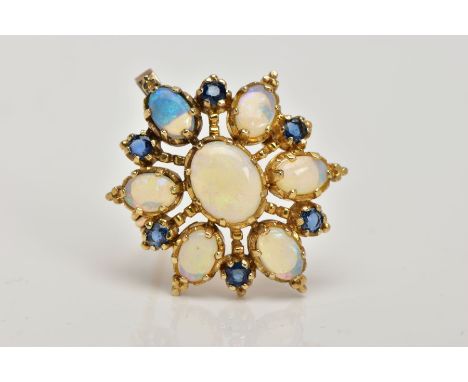 A 9CT GOLD OPAL AND SAPPHIRE BROOCH/PENDANT, designed as a central oval opal cabochon, surrounded by six opal cabochons, each