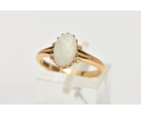 A YELLOW METAL OPAL RING, designed with a sixteen claw set, oval cut opal cabochon, measuring approximately 4.9mm x 1.4mm, tr