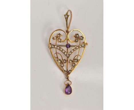 AN EDWARDIAN AMETHYST AND PEARL PENDANT/BROOCH, of an openwork heart shape, set with a circular cut amethyst within a seed pe