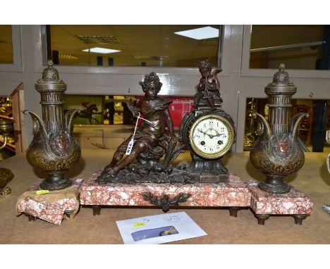 AN EARLY TWENTIETH CENTURY BRONZED SPELTER AND MARBLE CLOCK GARNITURE, the figural clock with painted enamel dial, Arabic num