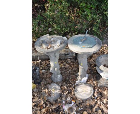 A COMPOSITE SUNDIAL AND A DISTRESSED BIRD BATH  with similar Cherub columns and round bases both 70cm high