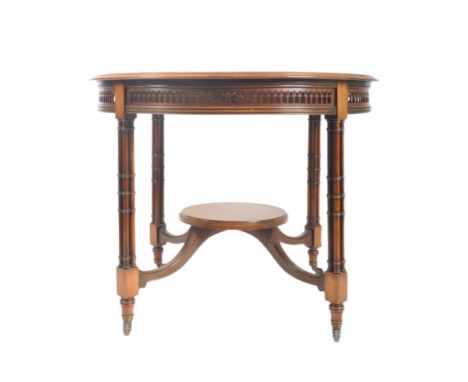 An Edwardian Chinese Chippendale revival mahogany circular centre table. The table having a chamfered top over a fretwork, pi