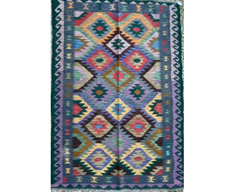 An early 20th century Anatolian Turkish Islamic Kilim hand woven floor carpet rug having a central panel decorated with repea