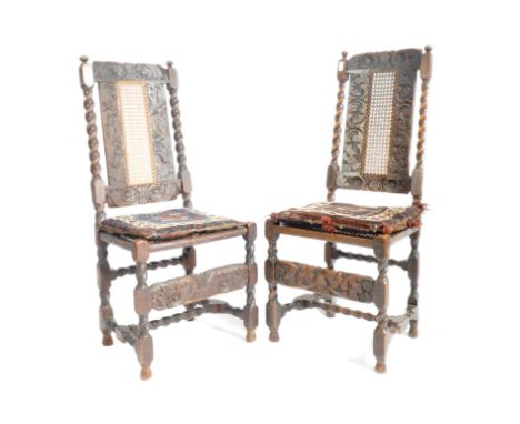 A pair of 17th century oak high back carved dining chairs. Each chair having a carved in relief back rest with central rattan