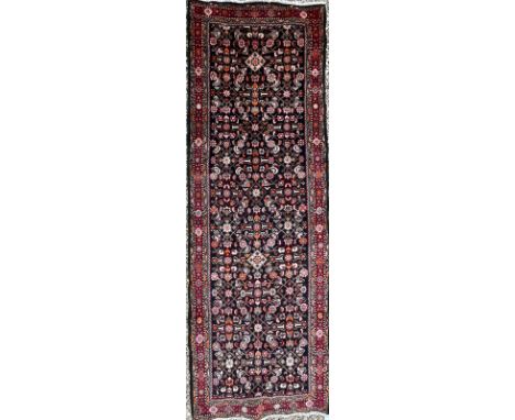 A late 19th century North West Persian Islamic Mahal hand woven runner floor rug having a central dark panel decorated with b