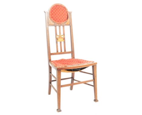 An Edwardian mahogany inlaid investiture chair being raised on tapered legs with stretchers having tall back rest with applie