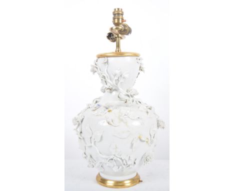 An 18th century Chinese blanc de chine Dehua porcelain vase converted to a lamp in 20th century France. Large size with the b