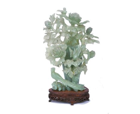 A 19th century Chinese carved jade lidded urn / vase in the form of a peony / rose bush, with blossoming flowers and leaves, 