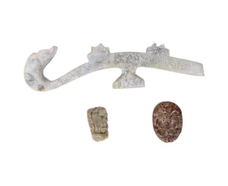 An assortment of of Qing Dynasty (1644-1911) Chinese hand carved jade tools & amulets. Collection comprising of a large celad