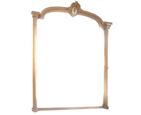 A very large 19th century overmantel wall mirror. Arched top with moulded details having a central white backed oval panel de