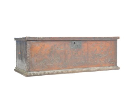A 17th century Italian Walnut Cassone - coffer chest. Raised on a gadrooned plinth base with carved detailed scene of knight 