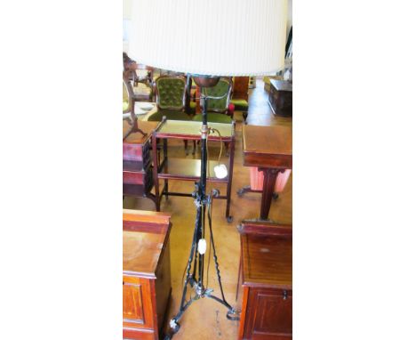A wrought iron standard lamp