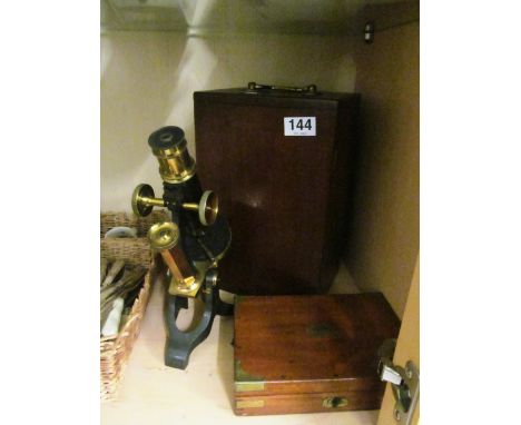 A microscope and lenses in mahogany case and a Negretti &amp; Zambra part geometry set in box