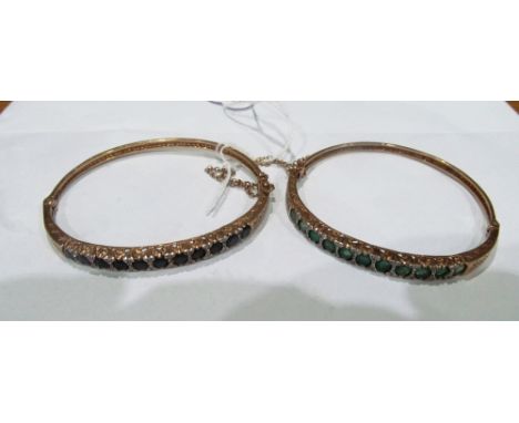 Two 9ct gold bangle bracelets one set green and white stones the other blue and white stones 25.3gms