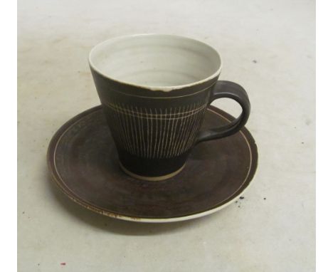 A Lucie Rie cup and saucer with sgraffito linear decoration, mark to base (chip to saucer rim)