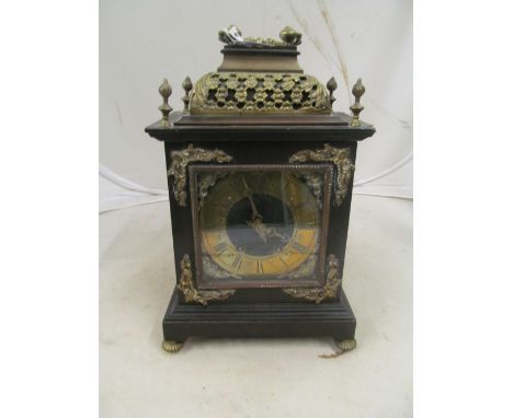 An ebonized Victorian bracket clock with gilt pierced floral dame top, brass chapter ring eight day striking movement