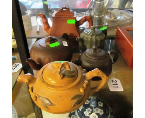 A Yixing teapot bamboo and prunus design, green fluted teapot, two colour teapot (cracked) and two Yixing teapots