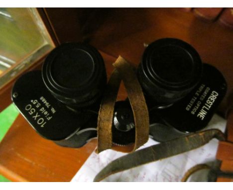 A pair of binoculars and a compass
