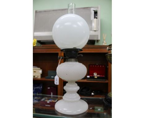 AN EDWARDIAN WHITE OPALINE GLASS OIL LAMP, with chimney and globe shade 