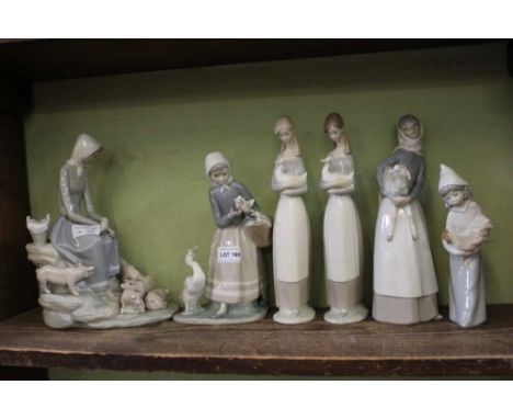 A SHELF FULL OF SPANISH PORCELAIN FEMALE FIGURINES the majority holding animals 