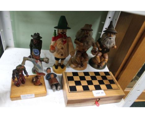 A SELECTION OF CARVED WOODEN FIGURES depicting three German smoking men, three comical figures &amp; a small sized chess set 