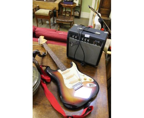 A FENDER SQUIRE SUNBURST FINISHED STRATOCASTER together with a fender frontman 15G amplifier 