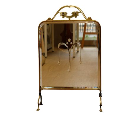 An early 20th Century brass fire screen with bevel-edged mirror insert, 78 cm x 48 cm