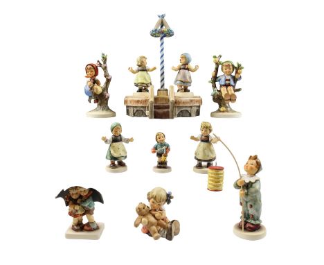 A group of ten boxed Goebel Hummel figurines together with a spring carrousel 