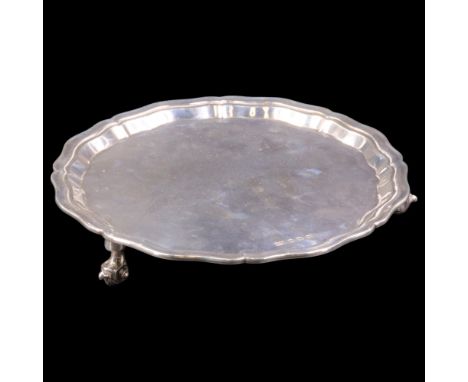 A 1930s silver waiter or small salver, having a Chippendale rim and raised on three volute feet, Viner's Ltd, Sheffield, 1939