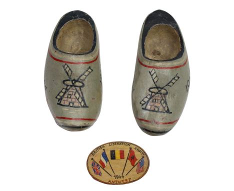 A 1944 Antwerp "British Liberation Army" painted wooden brooch, together with a pair of miniature wooden clogs inscribed "Joh
