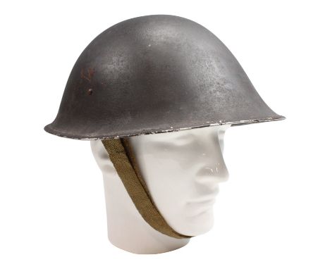 A British Army Mk III steel helmet, its liner dated 1944