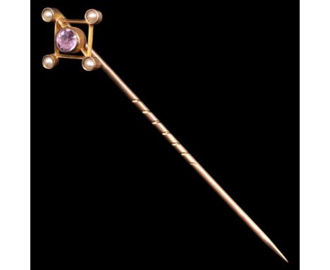 A Victorian amethyst, seed pearl and 9 ct gold openwork stick pin comprising a central bezel-set amethyst within a lozenge-sh
