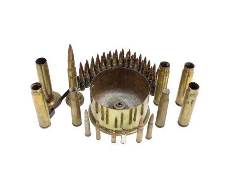 A small group of inert artillery and small arms shell cases together with belted ammunition and a "trench art" 50-caliber rou