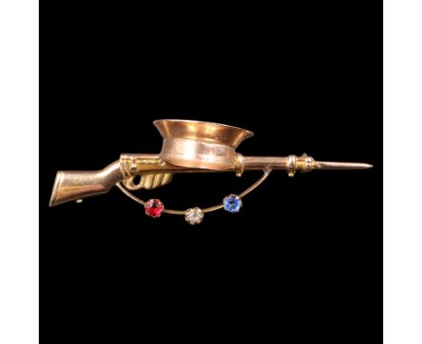 A Great War 9 ct gold sweetheart brooch in the form of a rifle and army peaked cap, the gun sling claw-set with small red, wh