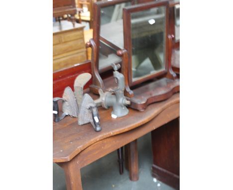 A vintage meat grinder, two flat irons, a Shoesmiths stand and two 19th century toilet mirrors with a Georgian painted serpen