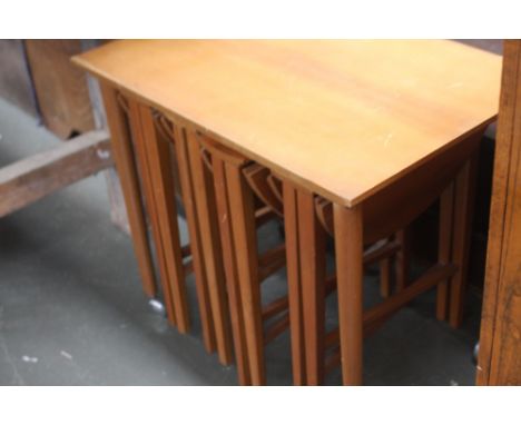 A 20th century side table raised on castors, with three smaller tables underneath