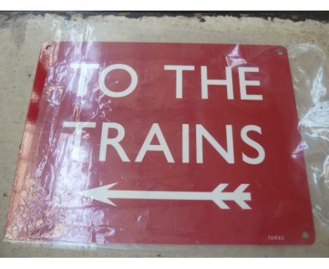 A red "To The Trains" enamel sign, arrow left