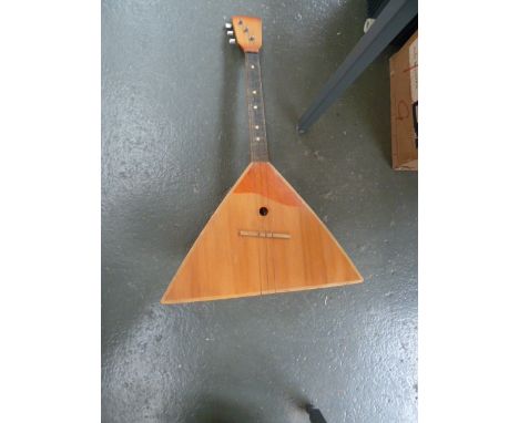 A three string triangular banjo/lute