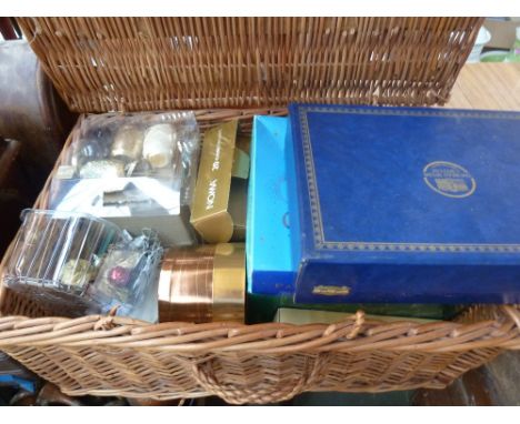 A box of various Christmas decorations in a wicker hamper including Christmas lights