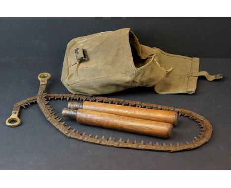 A British Military Issued World War Two Trench Saw, Complete With Handles In Original Bag, Dated 1944 And Marked With The Bro