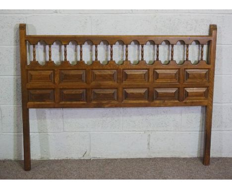 A vintage Adam style inlaid fire surround, 120cm high, 136cm wide; together with a small oak panelled headboard, 110cm high, 