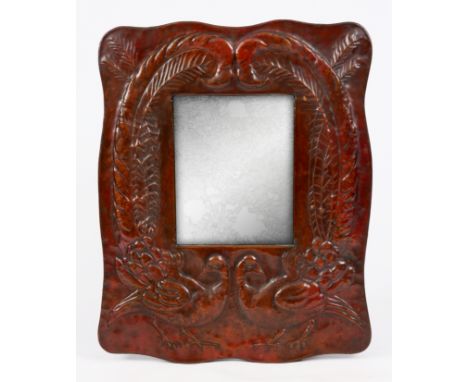 A STYLISH ARTS AND CRAFTS COPPER NEWLYN SCHOOL HANGING MIRROR attributed to John Pearson embossed with a pair of Peacocks, sh