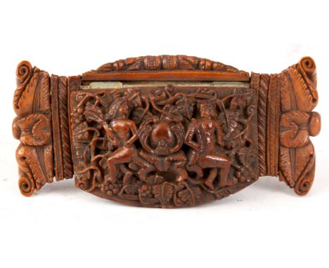 A 19TH CENTURY COQUILLA NUT SNUFF BOX finely carved depicting religious scenes and a coat of arms to the hinged lid, with scr