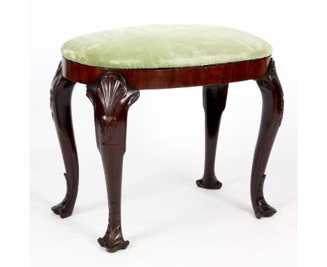 A GEORGE I MAHOGANY OVAL DRESSING STOOL with pale green velvet upholstered seat above a cross banded frieze and raised on fou