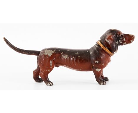 AN EARLY 20th CENTURY COLD PAINTED METAL LIGHTER IN THE FORM OF A DACHSHUND DOG with glass eyes and gilt brass collar stamped