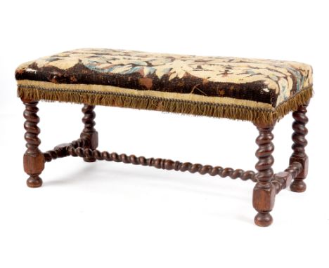 A LATE 17TH CENTURY OAK BARLEY TWIST DOUBLE STOOL with original tapestry seat and ‘H’ stretcher 93cm wide 43cm deep 47cm high