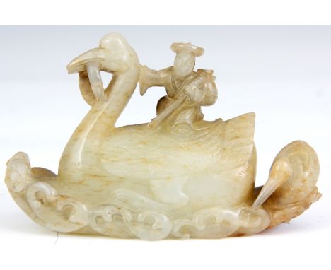 A CHINESE 18TH CENTURY JADE CARVING of a fisherman seated on a bird 8.5cm across 5cm high 